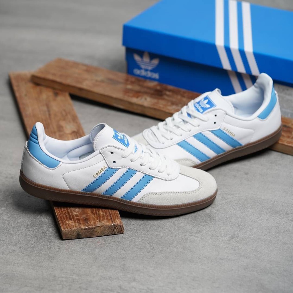 white and blue adidas samba