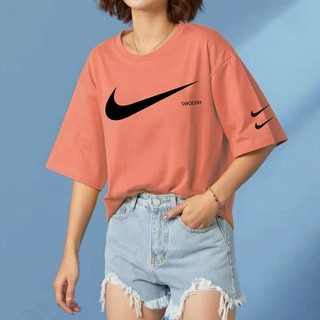 peach color nike shirt