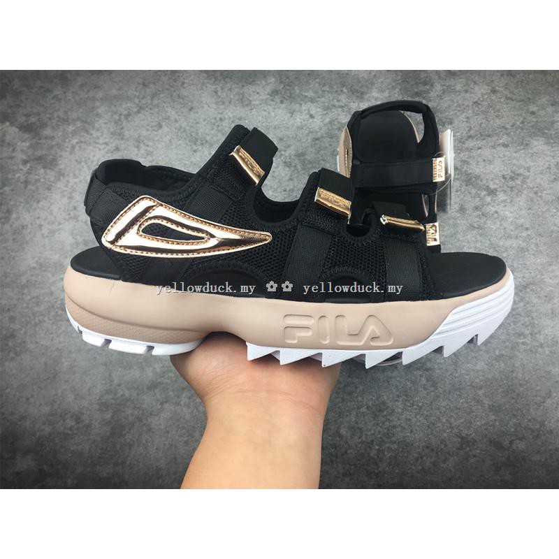black and gold fila disruptor