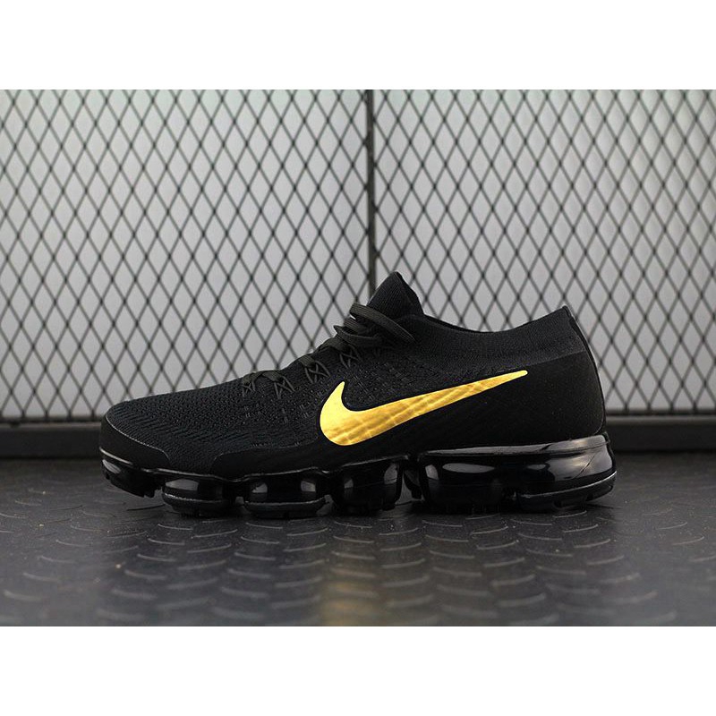 nike shoes black gold
