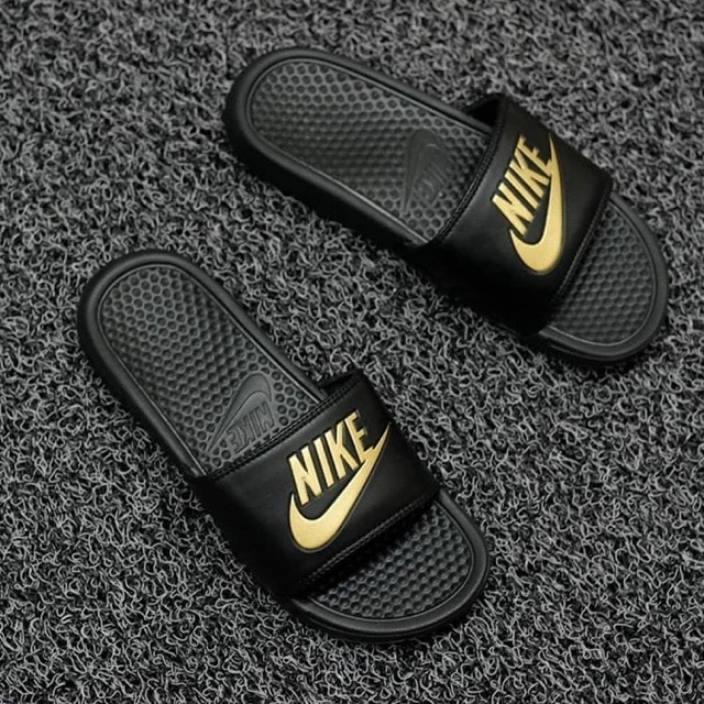 gold and black nike sandals