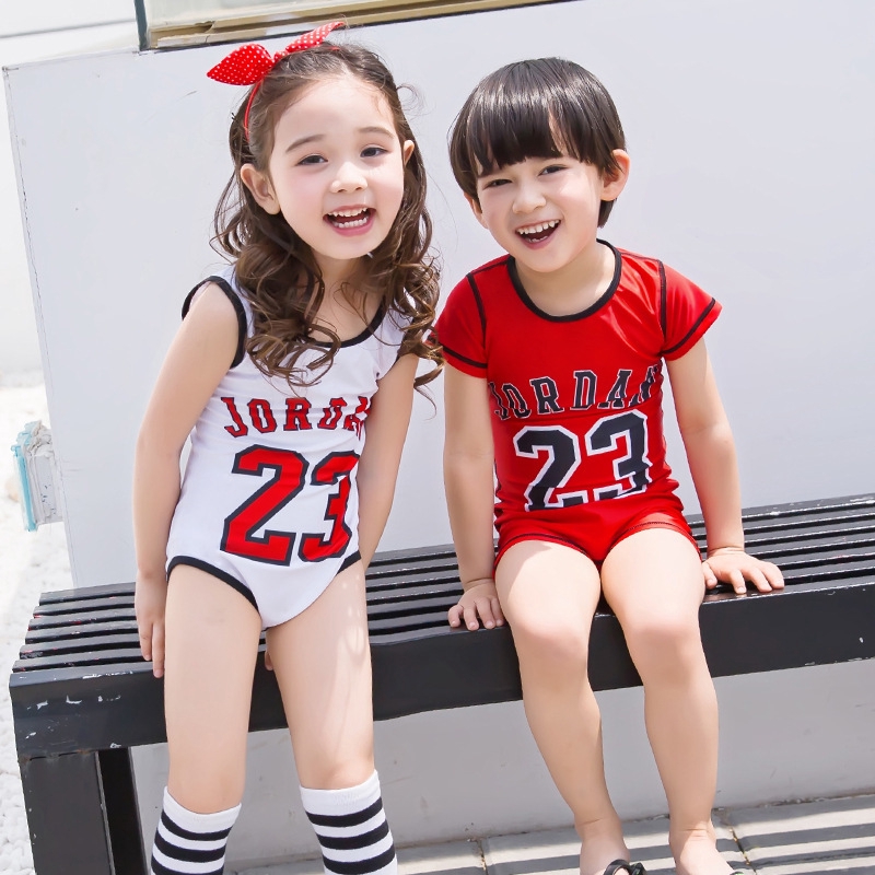 boy in girl's one piece swimsuit