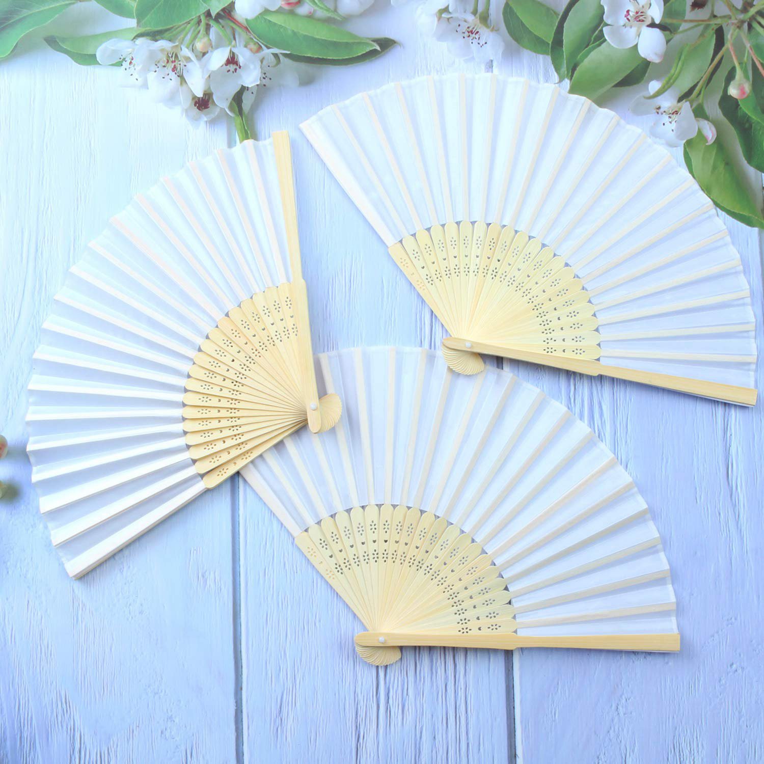 white hand held fans