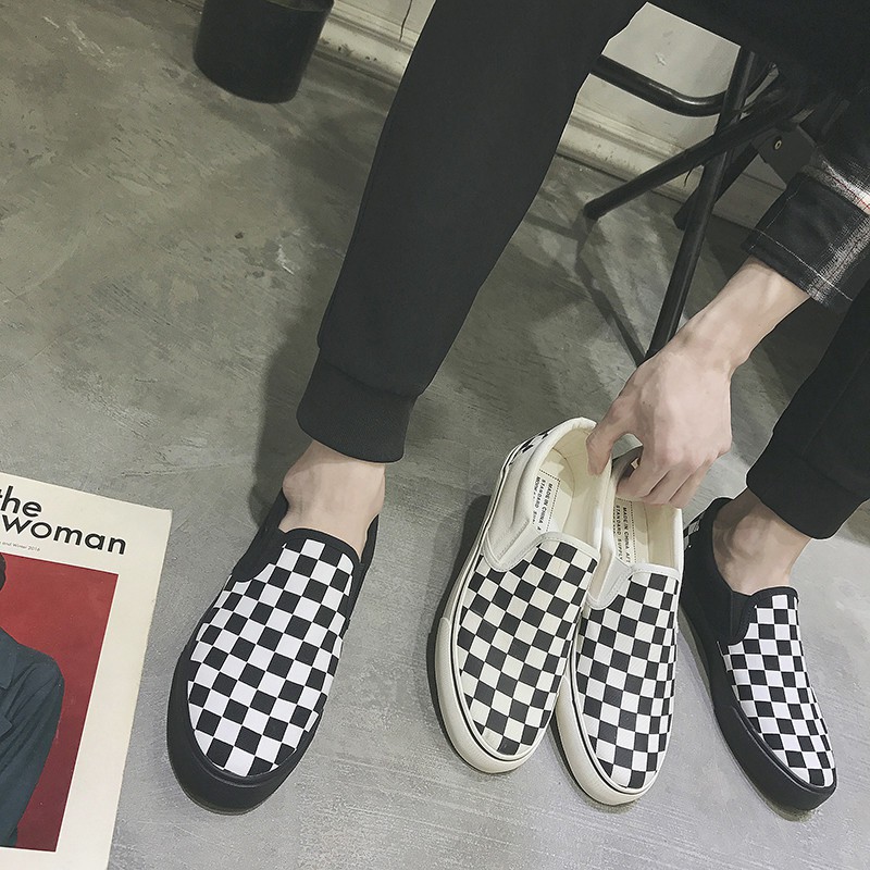 white slip on vans on feet