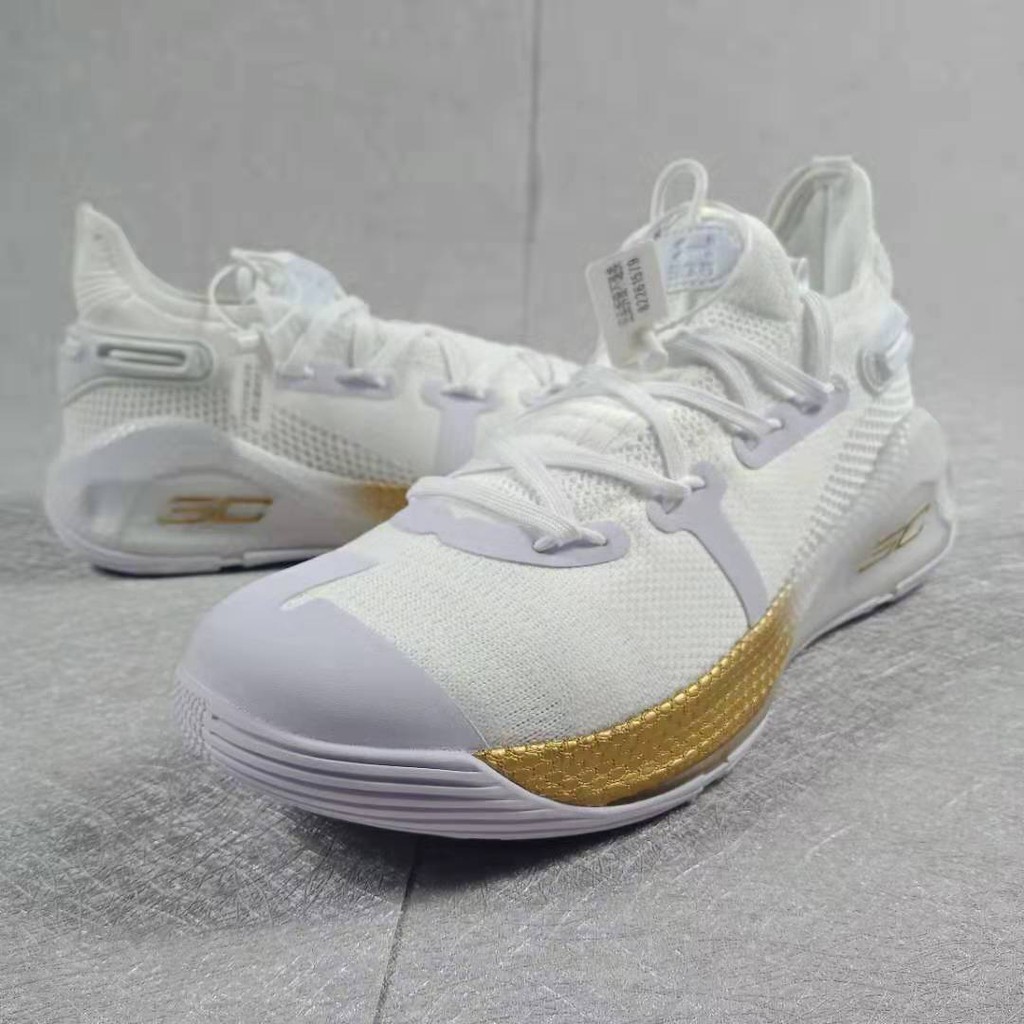 white and gold under armour basketball shoes