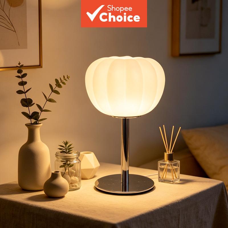 Table lamp with white pumpkin plastic lampshade and black metal base. USB-powered LED ambient bedsid